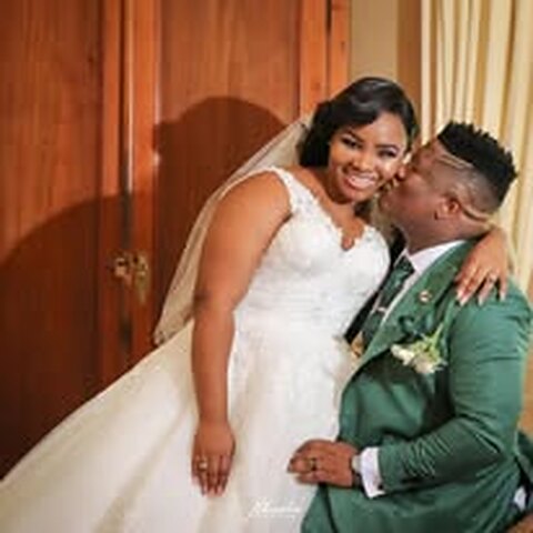 Yanga in his sage-green wedding suit, with his bride